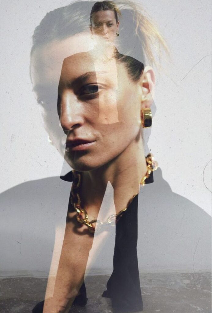 Artistic fashion photo featuring a double exposure of a woman’s face wearing bold gold jewelry layered with a full-body silhouette in black attire, creating a dramatic and modern visual effect.